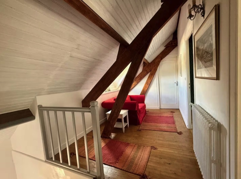 The attic sitting area beneath exposed beams