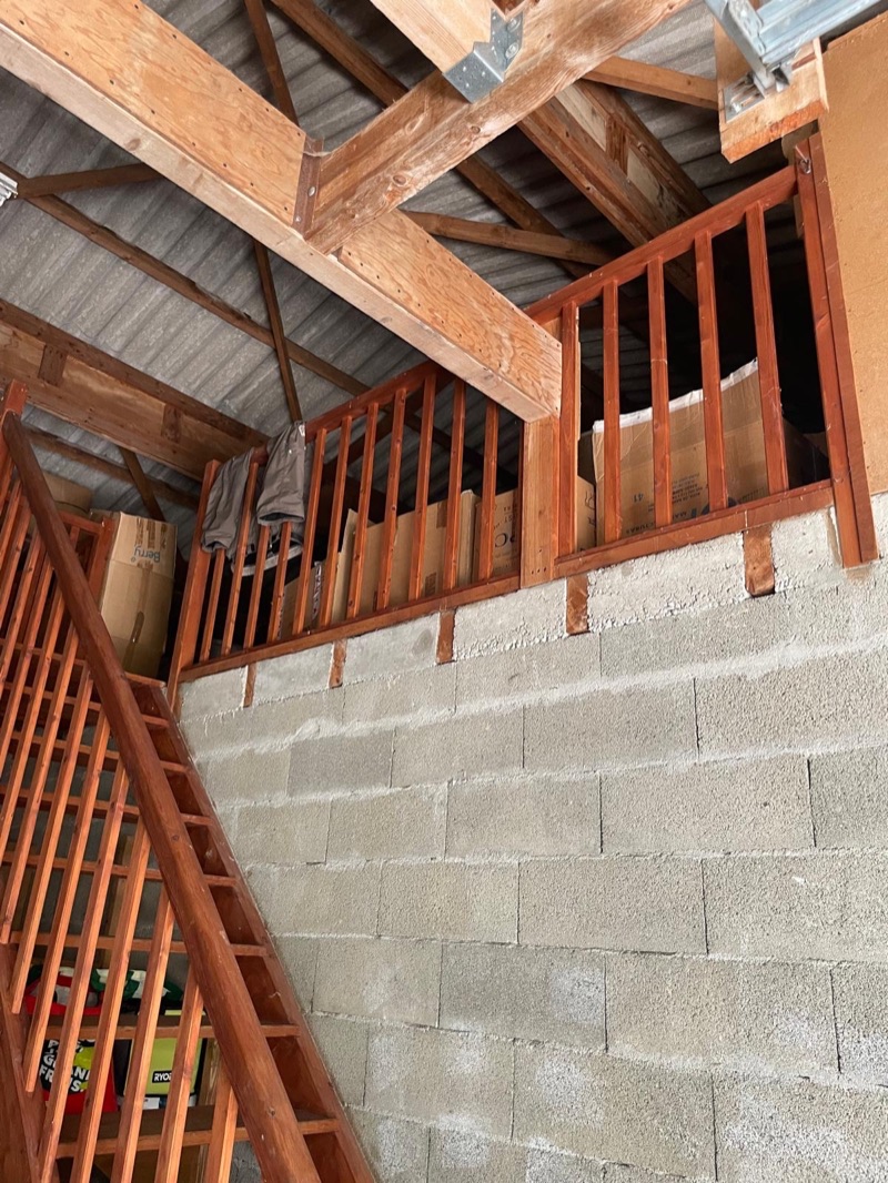Timber stairs and lofted storage area inside the outbuilding